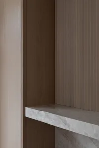 A minimalist interior design featuring marble and concrete materials.