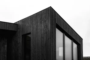 Black exterior architectural structure covered in charred-shou sugi ban wood