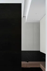 Modern closet interior featuring gray tiles and black ground.