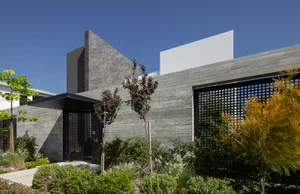 Modern building with concrete facade and plants