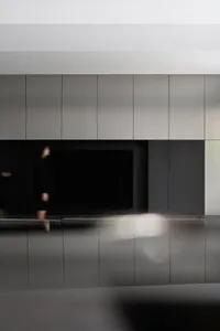A modern living room featuring a black and white color palette with metallic accents.