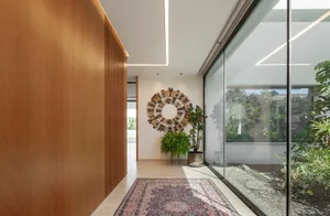 A modern living room featuring a wooden floor and natural light.