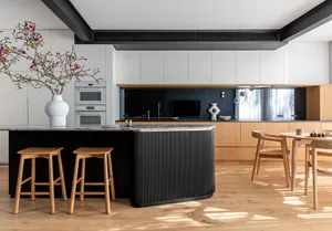 A modern minimalist kitchen with black and white color scheme, featuring a wooden island and marble countertops.