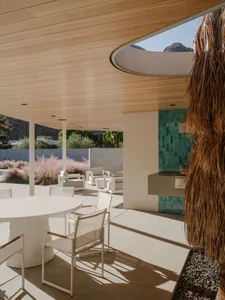Modern outdoor living space with concrete, glass, and wood materials