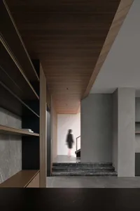 A minimalist modern entryway with concrete and wooden elements