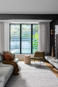 A modern living space featuring concrete and glass materials.