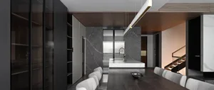 A modern kitchen and dining area featuring marble surfaces.