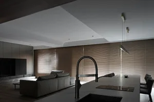 Contemporary, minimalist living room with sleek, modern furniture and a muted color palette.