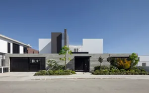 A modern house featuring a contemporary design with concrete as the primary material.