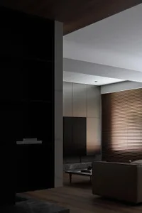 Modern minimalist living room featuring wooden ceiling panels and sleek, contemporary furniture.