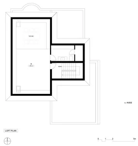 A two-level residential layout with a spiral staircase leading from the ground level to the loft level. The ground level feat