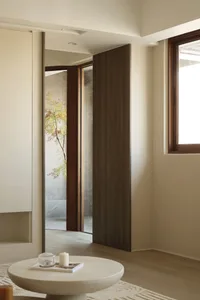 Modern minimalist interior with wood and stone materials.