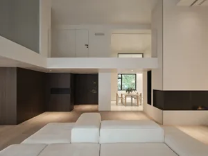 Modern minimalist living room with wooden furniture, concrete accents, and textiles on the floor.