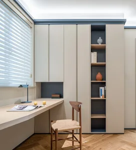 A minimalist home office featuring neutral-toned furniture and decor.