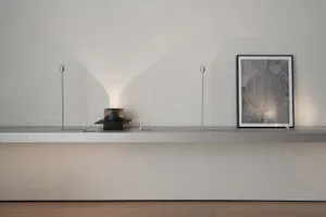 A minimalist wall art piece featuring a circular pattern made of metal.