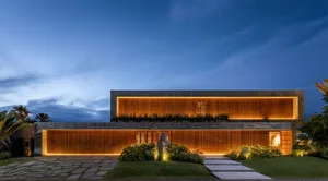Modern architectural building with concrete facade illuminated at dusk with soft lighting.