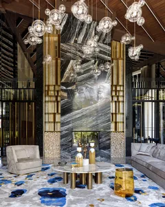 Modern lobby with marble fireplace, armchair, and coffee table.