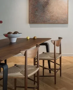 Modern dining room with wooden chairs and a wooden table.