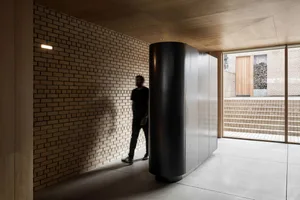 A modern hallway featuring brick and concrete materials.