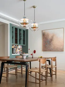 A modern interior design featuring wood, glass, and metal elements.