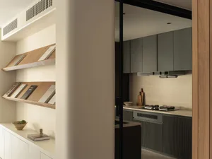A modern residential kitchen featuring wooden cabinets and a stone backsplash.