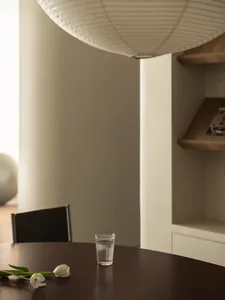 A minimalist interior with wooden furniture and glass elements.