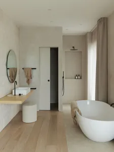 Modern bathroom with concrete walls, a freestanding bathtub, and minimalist design.