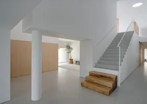 Modern interior design featuring a wooden and concrete staircase.