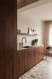 Contemporary kitchen with terrazzo countertops and wooden cabinets.