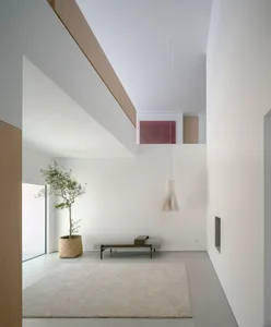 A contemporary, minimalist interior with a combination of light concrete and wooden elements.