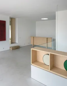 Modern minimalist living room with wood elements, featuring clean lines and a focus on natural materials.
