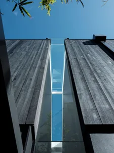 A modern building with a glass walkway connecting two structures.