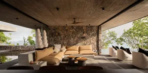 Modern minimalist living room with concrete and stone accents.