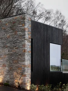 Modern building exterior featuring stone and wooden accents