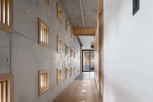 A modern corridor with concrete walls and wooden floor and LED lighting