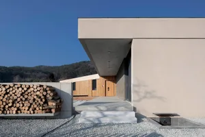 A modern residential building with concrete walls and a minimalist design.