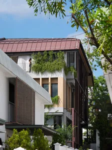 Modern building exterior featuring a green roof with plants.