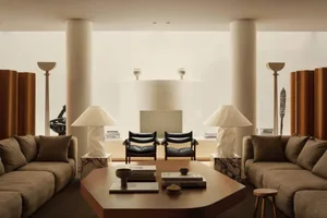 A modern living room featuring concrete, leather, and marble materials.