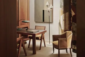 A modern dining table with a wooden finish, featuring a menu or cookbook placed on top.