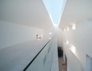 A minimalist modern interior designed with concrete and glass materials.