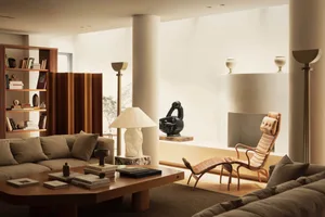 Modern living room featuring wooden furniture, leather accents, and a marble coffee table.