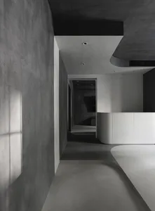 Modern office space featuring concrete flooring and walls