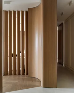 Modern interior design featuring a wooden, curved screen partition.