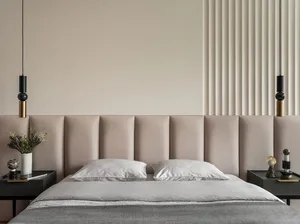 Modern bedroom with fabric headboard and pillows, featuring contemporary design elements.