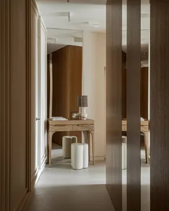 Modern interior design featuring a wooden corridor with patterned cushions and a wooden table.