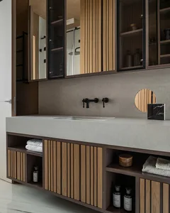 Modern bathroom with concrete vanity, wooden cabinets, and minimalist design.