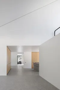 Modern kitchen with concrete floor and minimalist design.