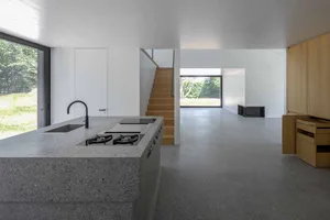 Modern kitchen featuring a concrete countertop with a built-in stove and sink.