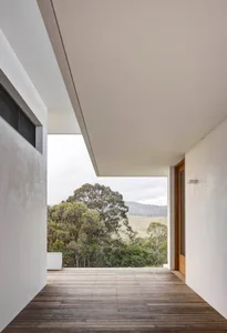Wooden floor of a minimalist residential exterior with views of the countryside.