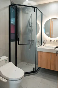 Modern bathroom with glass shower enclosure and wooden vanity